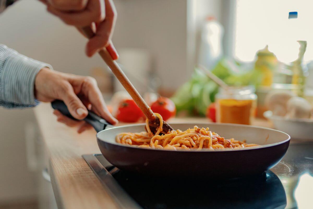A picture shows someone cooking pasta.