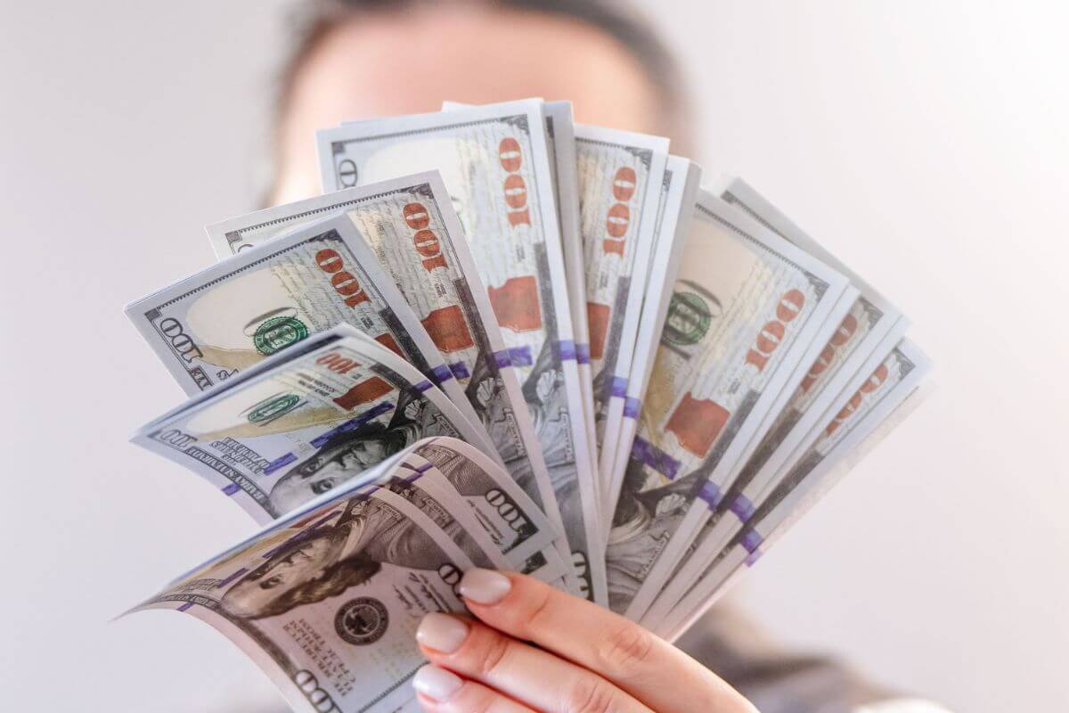 A picture of someone holding a lot of money.
