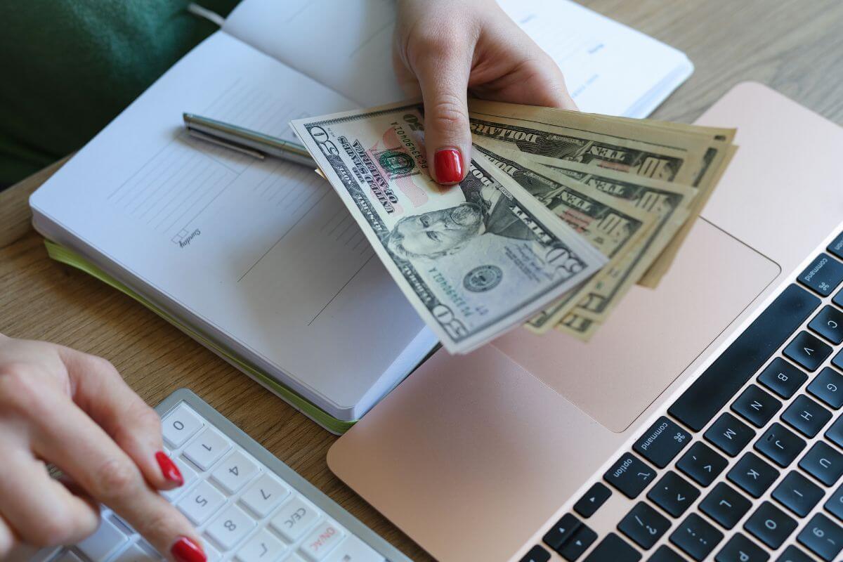A picture of someone counting money. 
