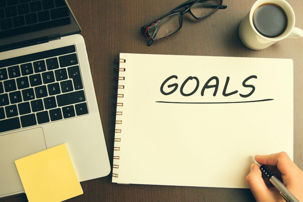 A picture of someone writing their goals. 