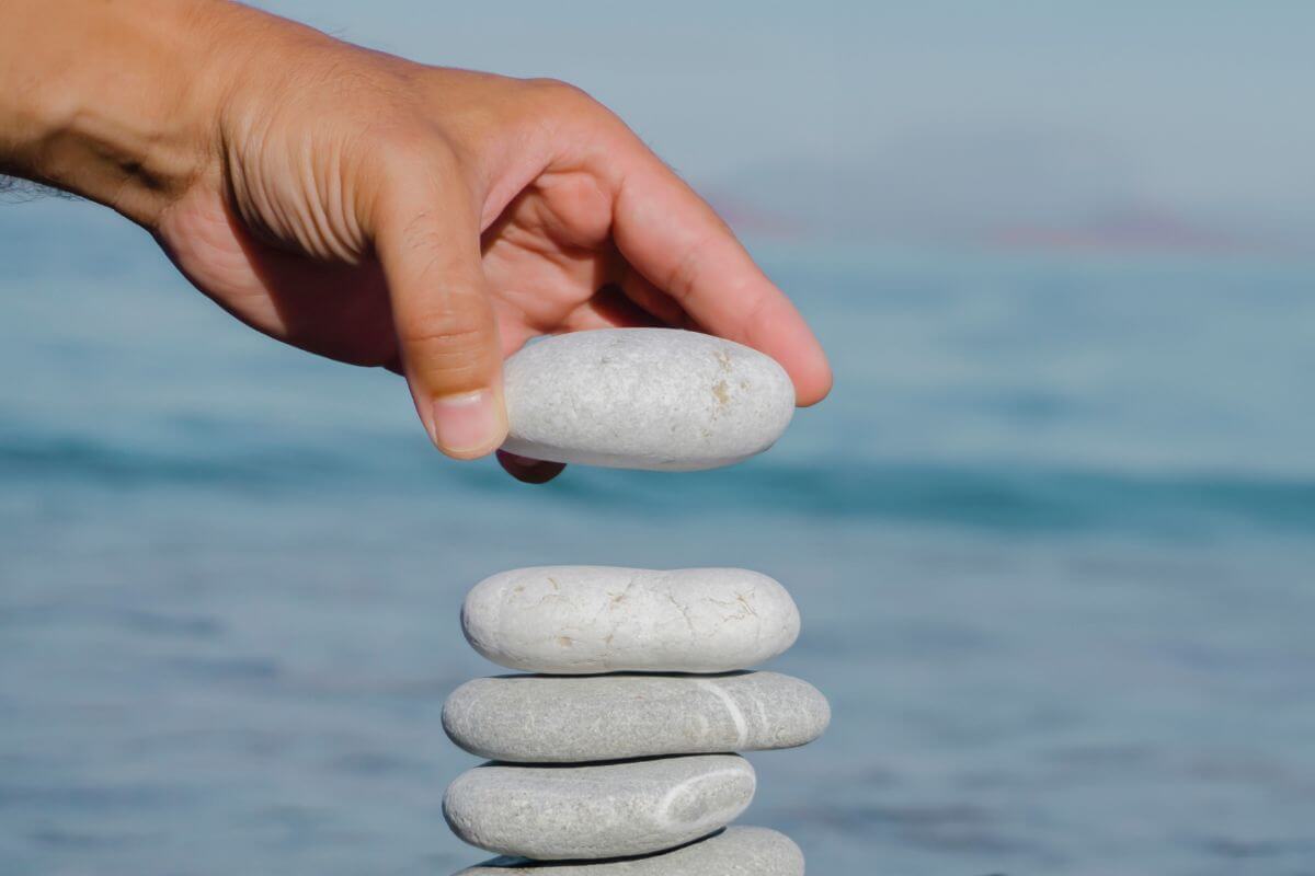 A picture of someone putting stones on top of each other.