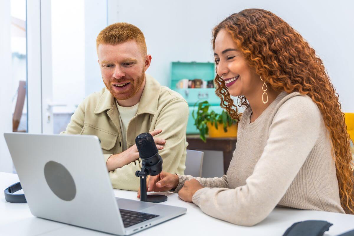 A picture of a man and a woman watching something.
