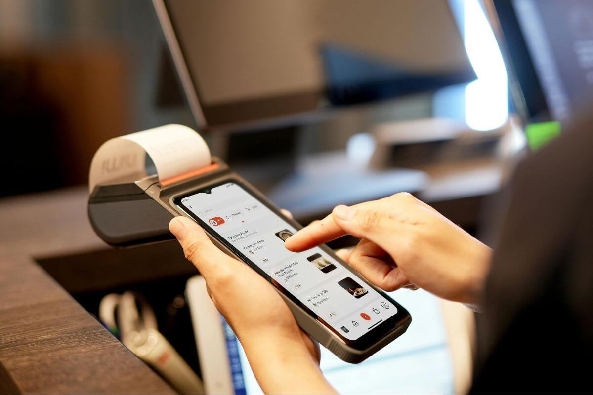 A picture of someone using wireless paying.