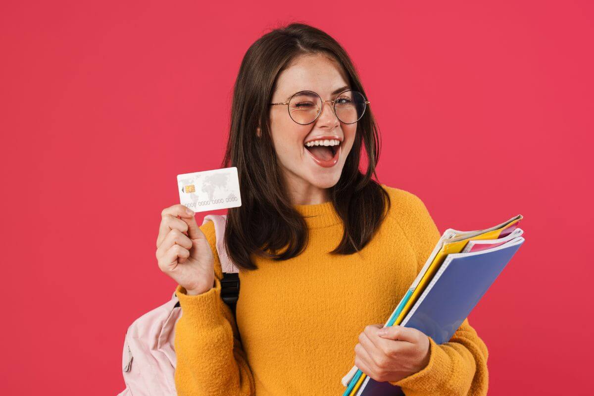 A picture of a student with a credit card.