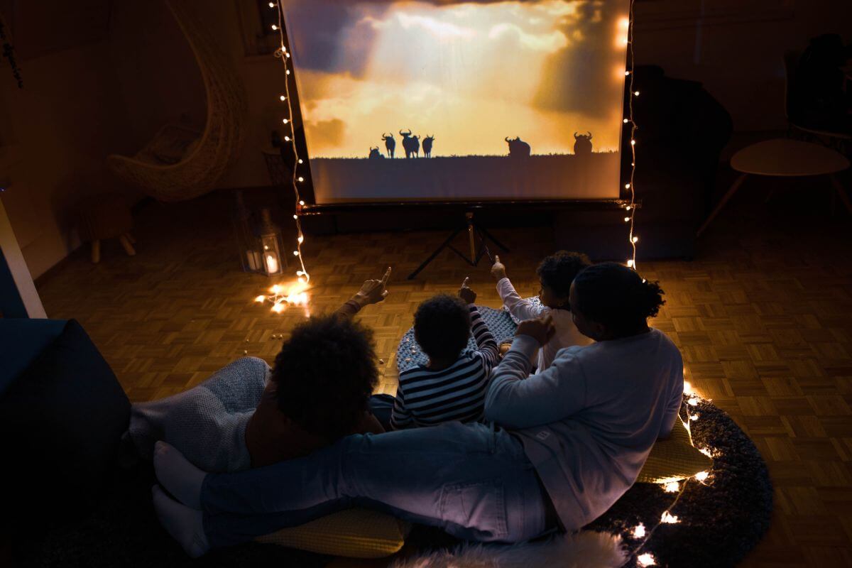 A picture shows a family watching a movie.