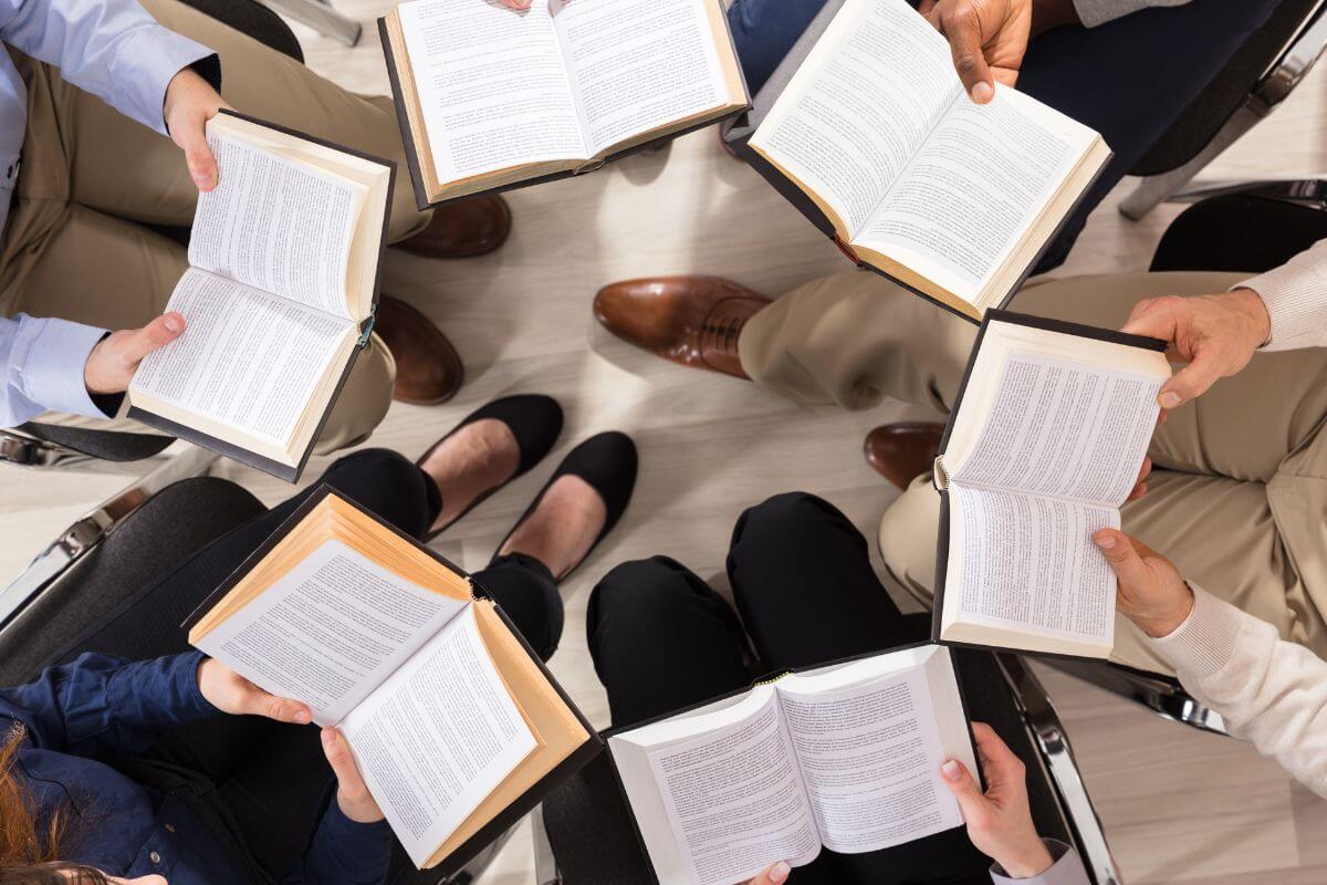 A picture shows a group of people reading books.