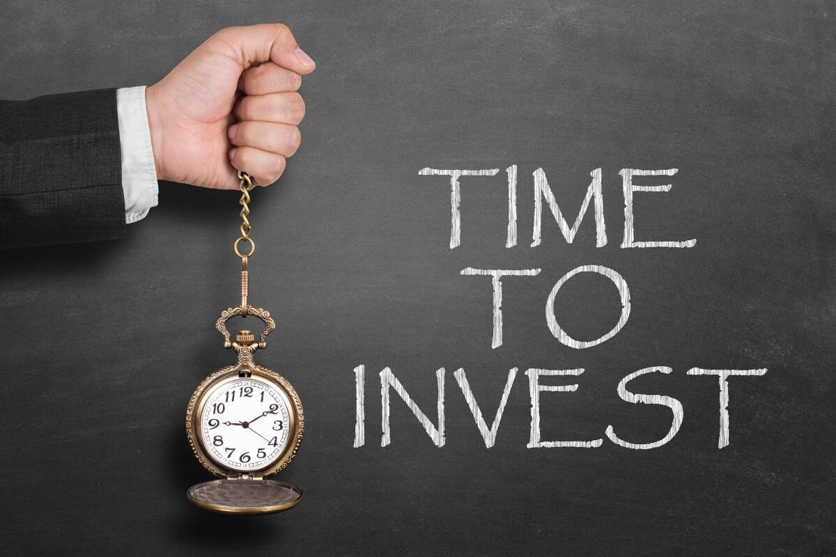 An image shows the time to invest wording on the board.