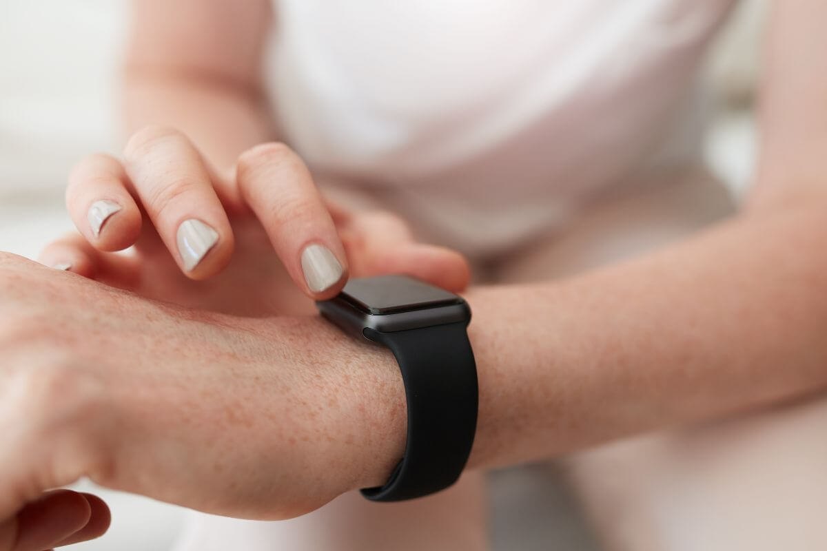 An image shows a woman checking her watch.