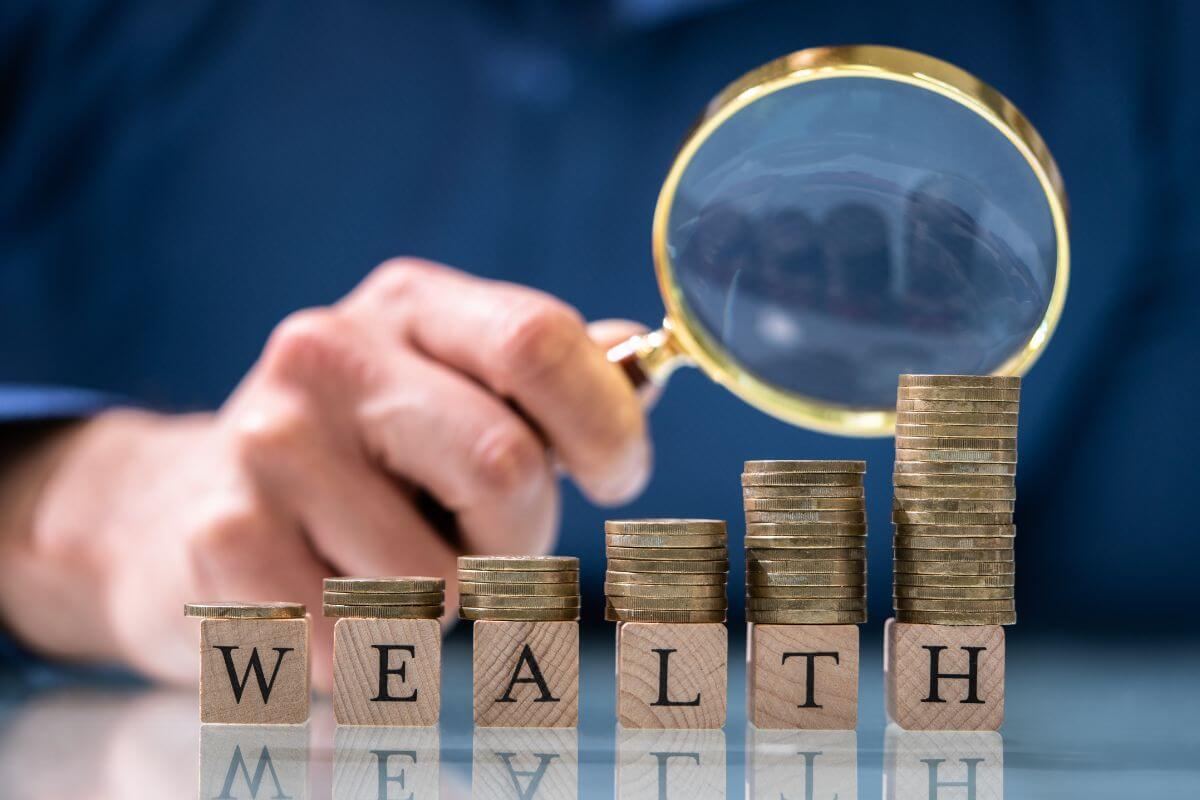 A picture shows stacks of coins and wealth wording.