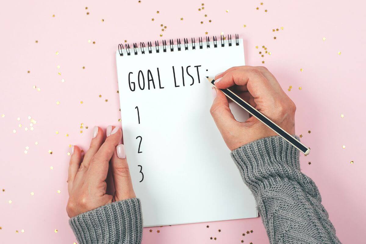 A picture of a woman making a goal list.