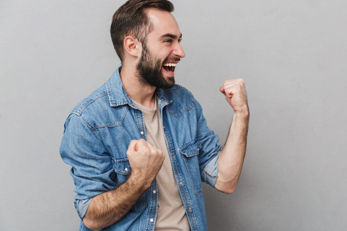 An image of a man cheering.