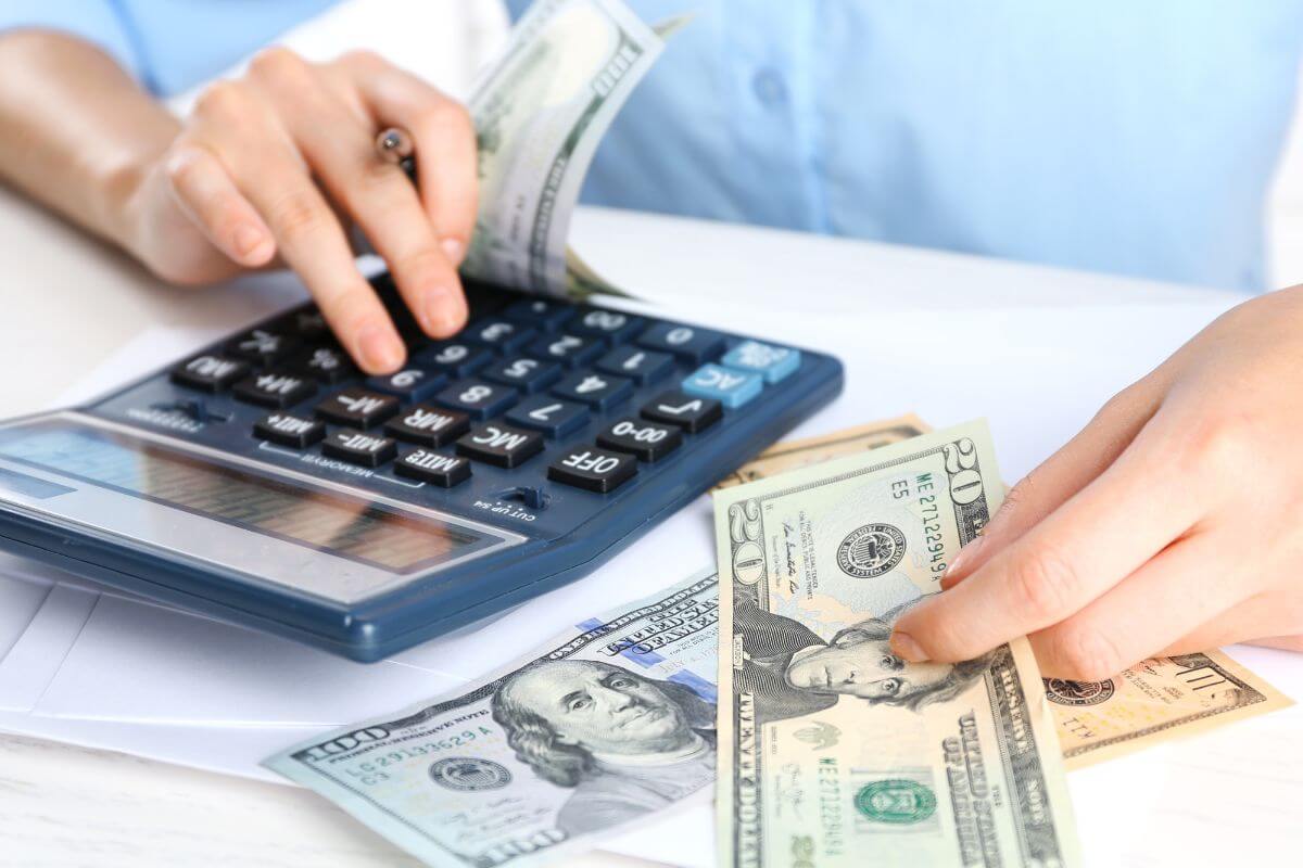 An image of a woman calculating money.