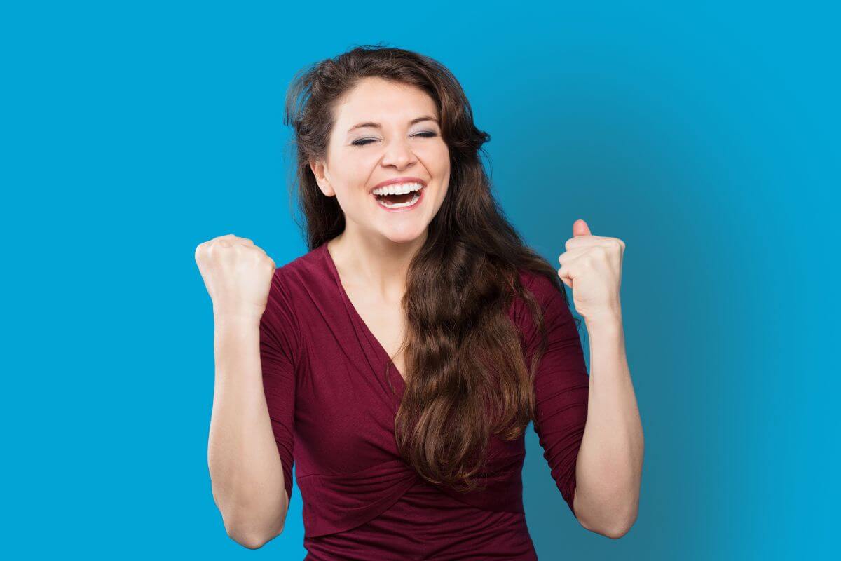 An image of a woman cheering.