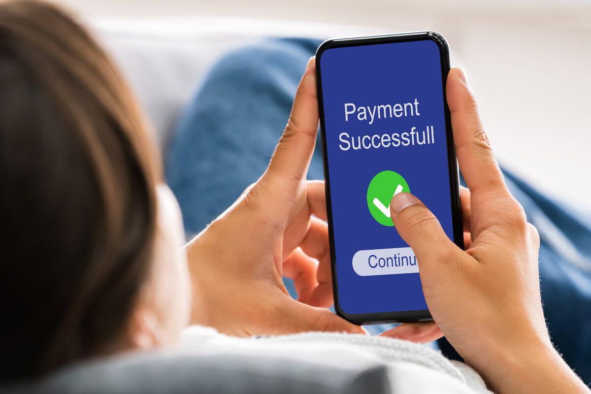 An image shows a woman making an online payment.