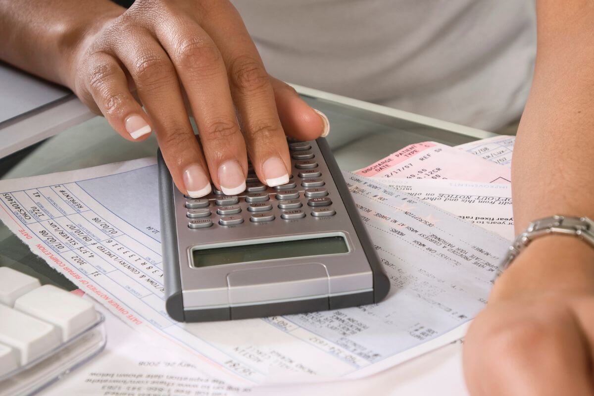 A picture shows a woman tracking her expenses.