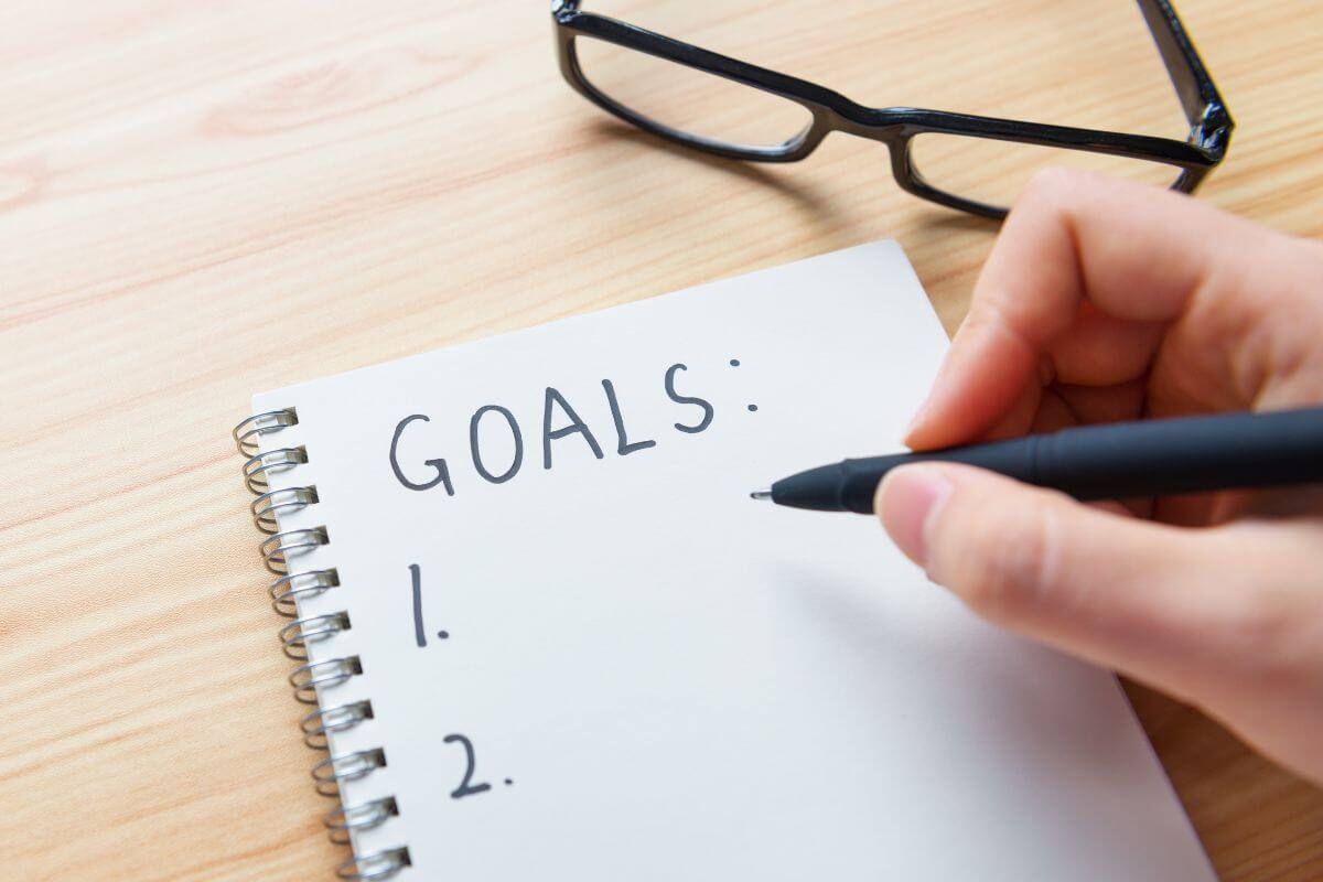 A picture shows a woman's hand setting goals.