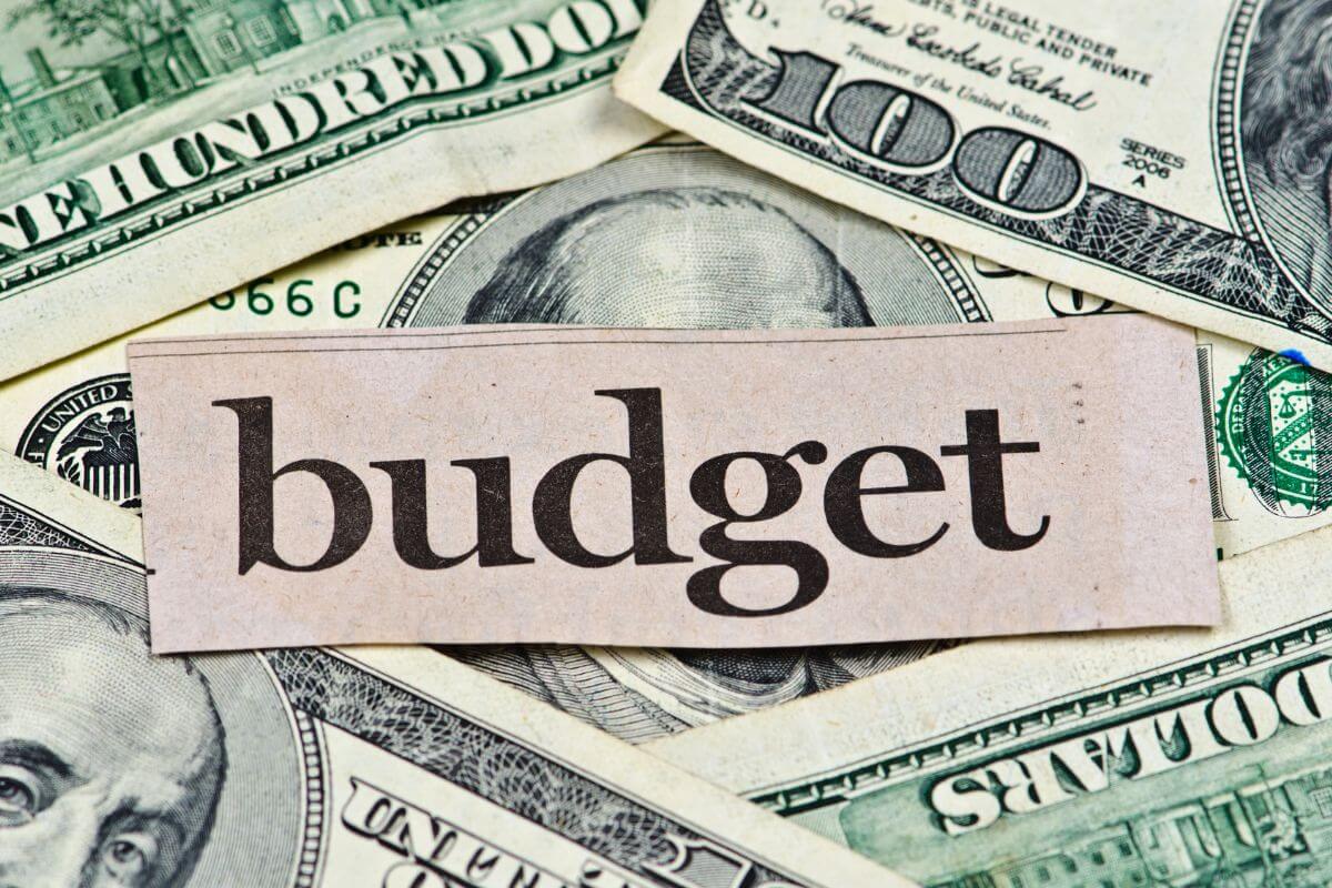 A picture shows money and budget wording.