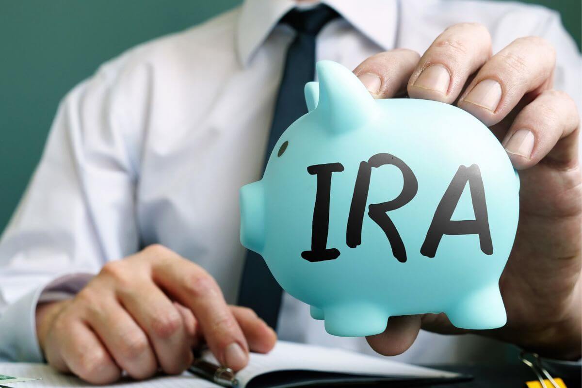 An image of a man holding a piggy bank.