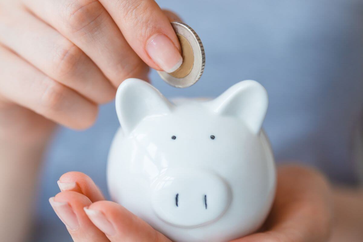 A picture shows a woman's hand saving money.