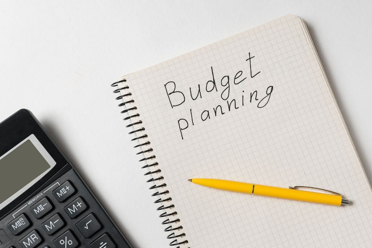 An image of a notebook with budget planning wording.