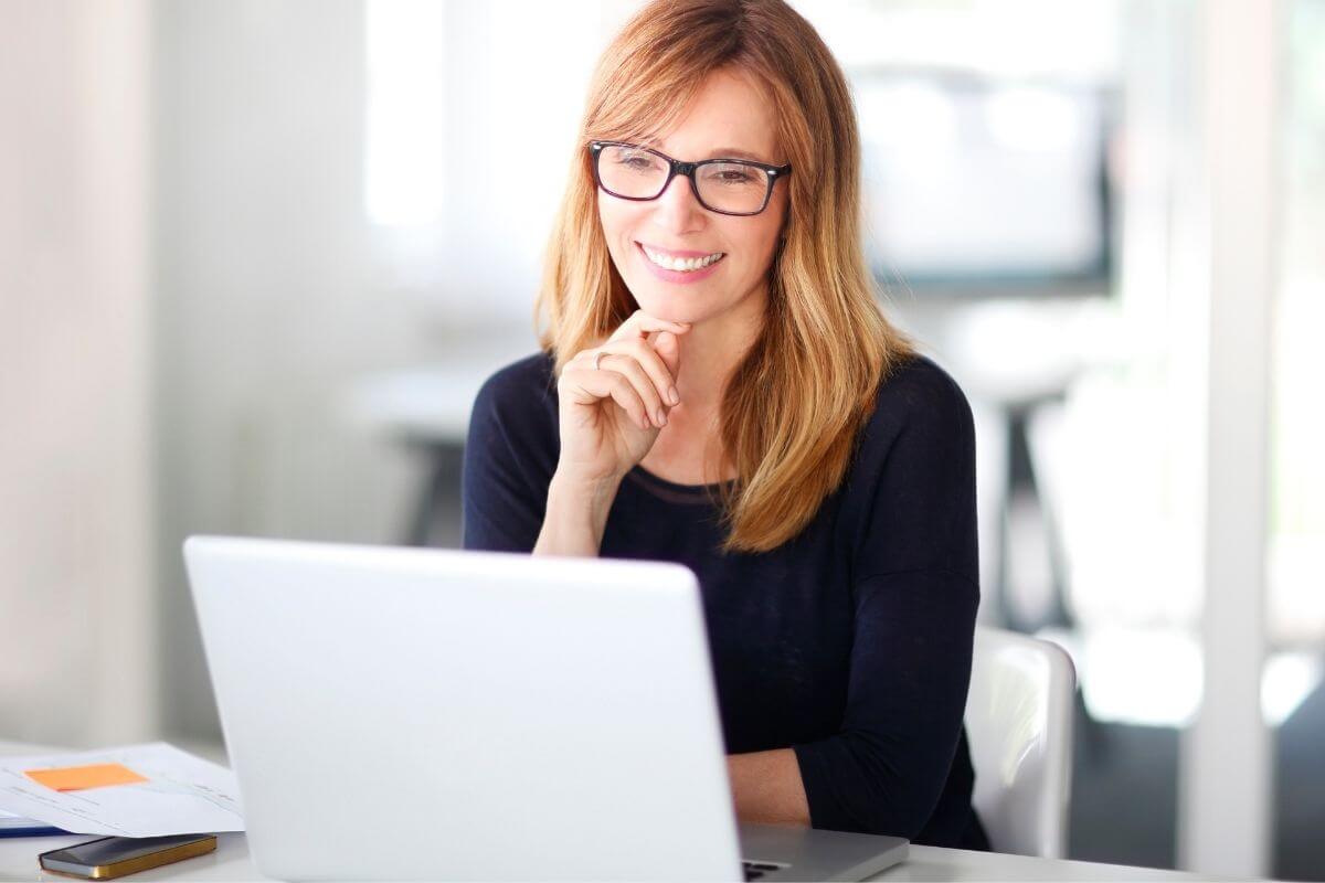 An image shows a woman using a laptop.