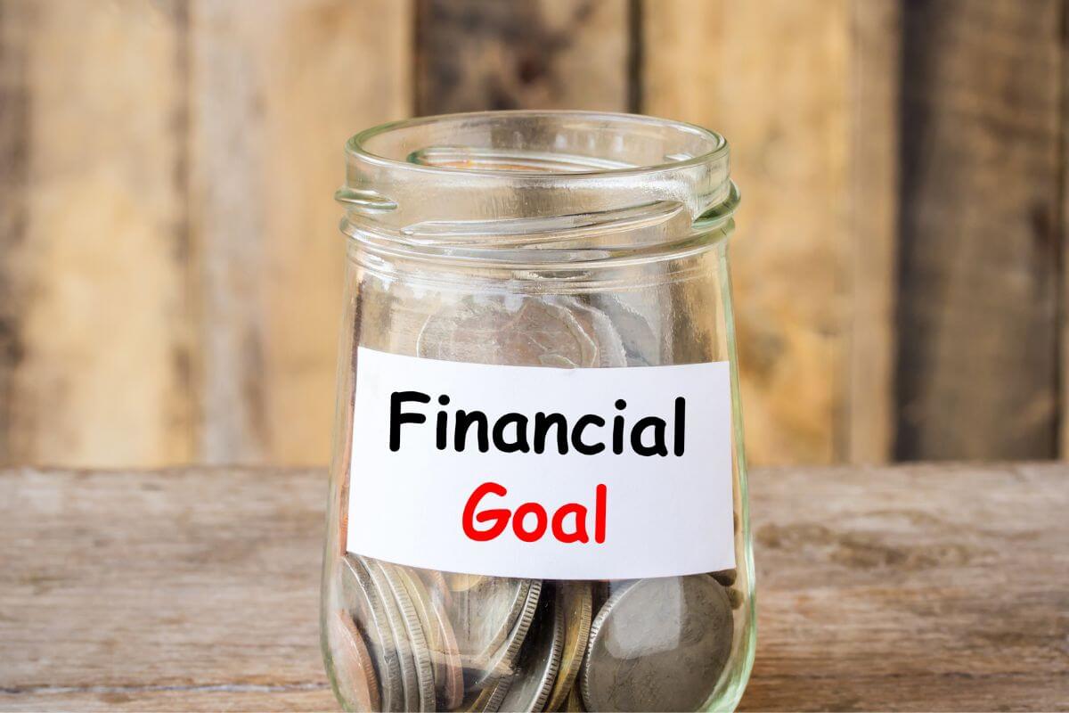 An image shows a jar with money and a financial goal label.