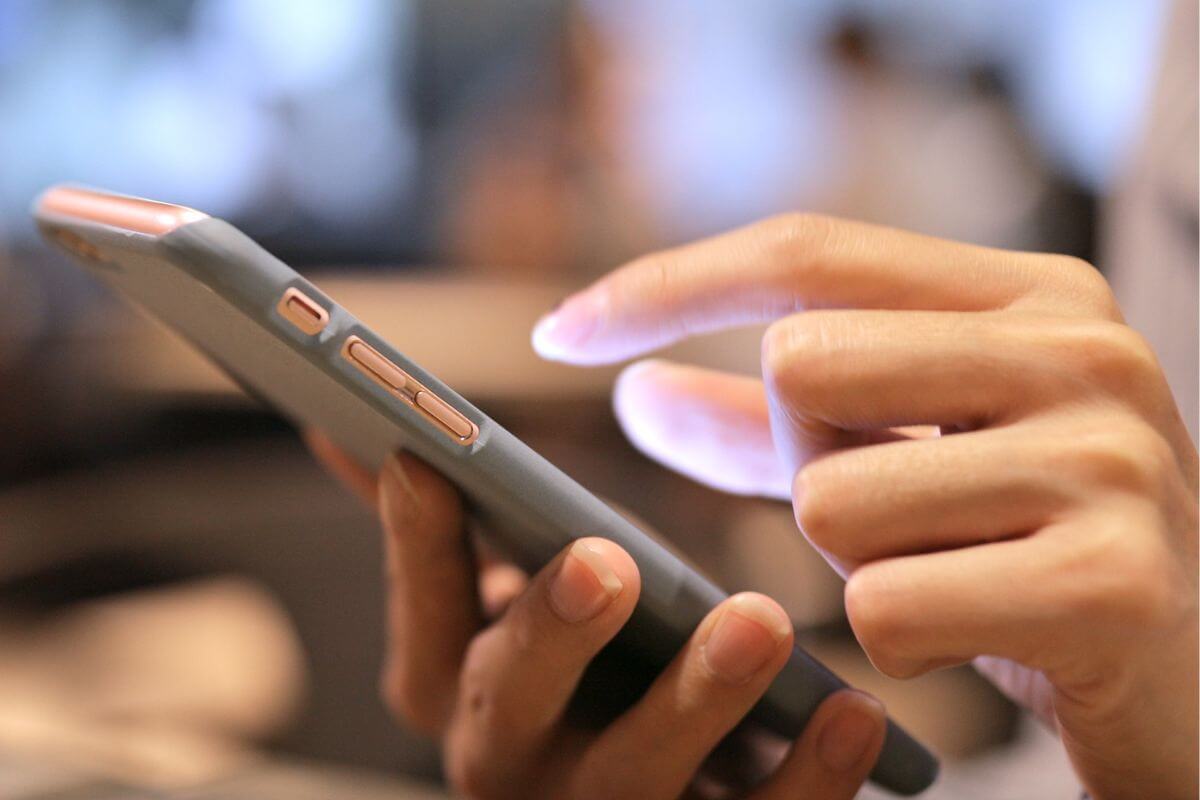 An image of a woman's hand using a phone.