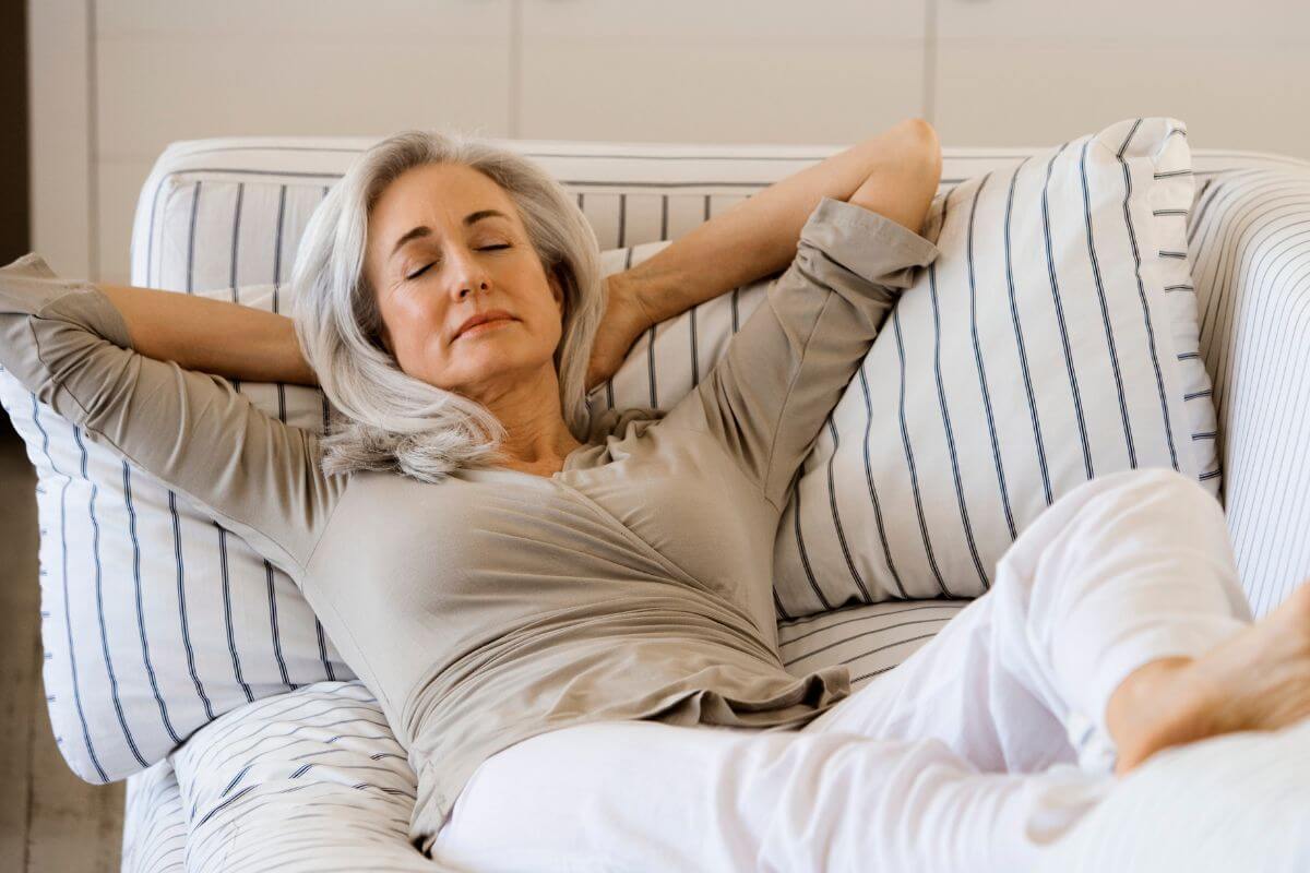 An image of a woman relaxing on the couch.