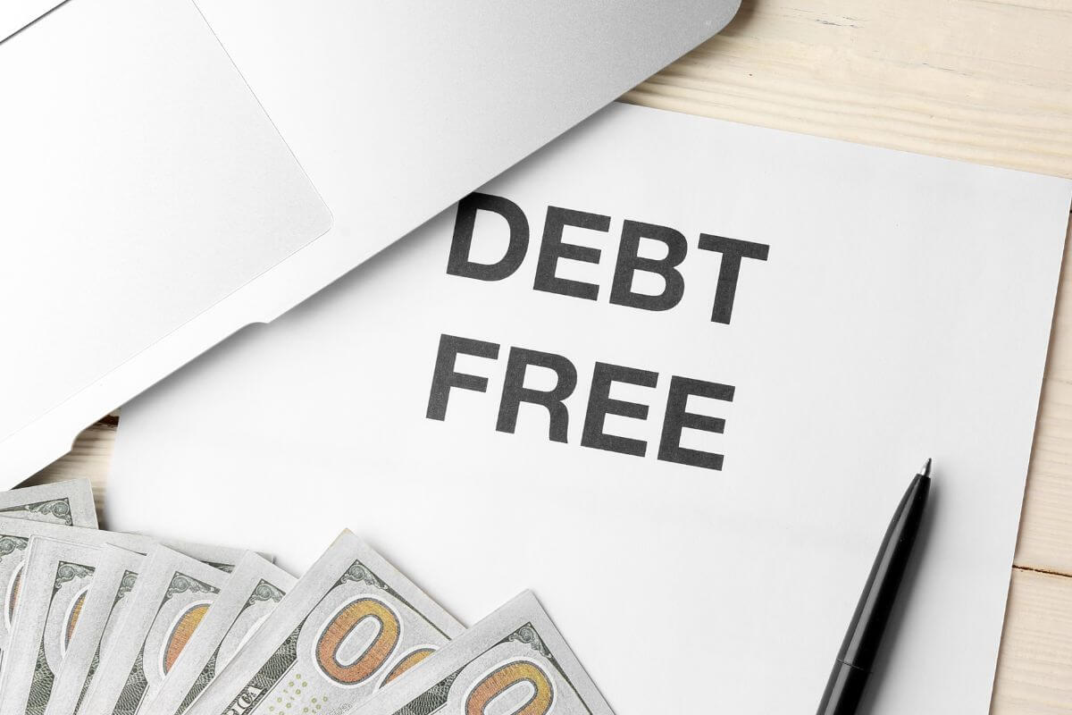 A picture shows a paper with debt-free wording.