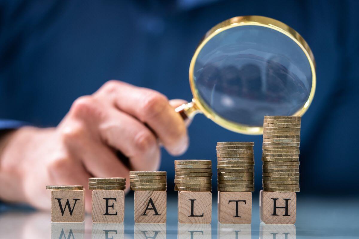 A picture shows stacks of money and wealth wording.