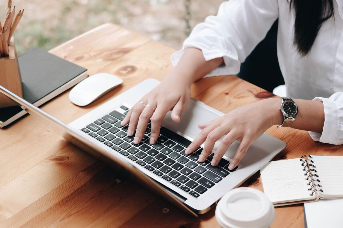 A picture shows a woman working on a laptop.