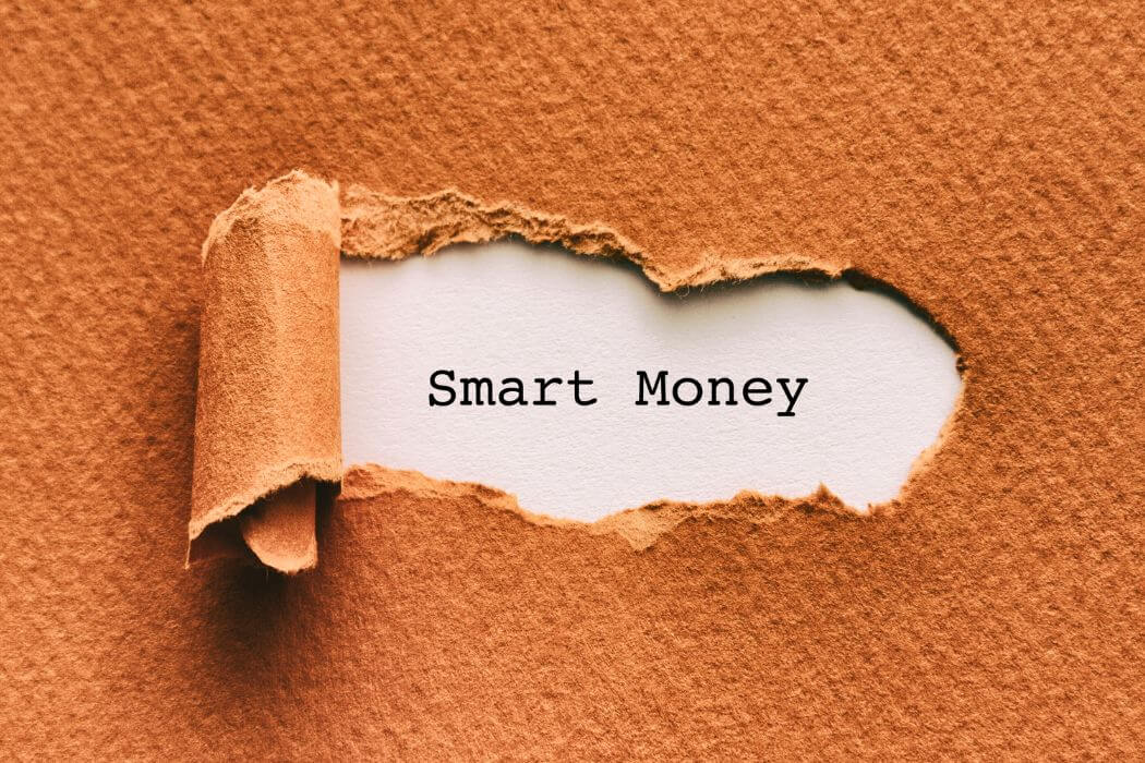 An image shows a torn paper with smart money wording.