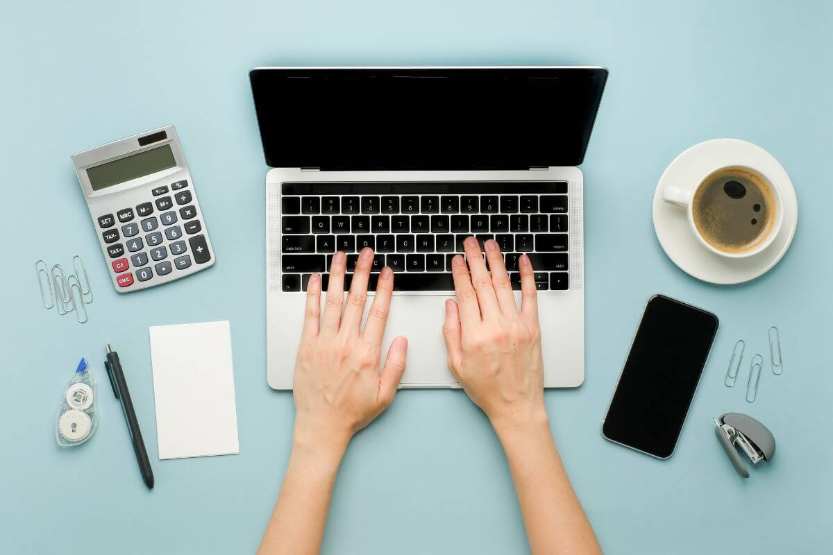 A picture shows a woman's hand using a laptop.