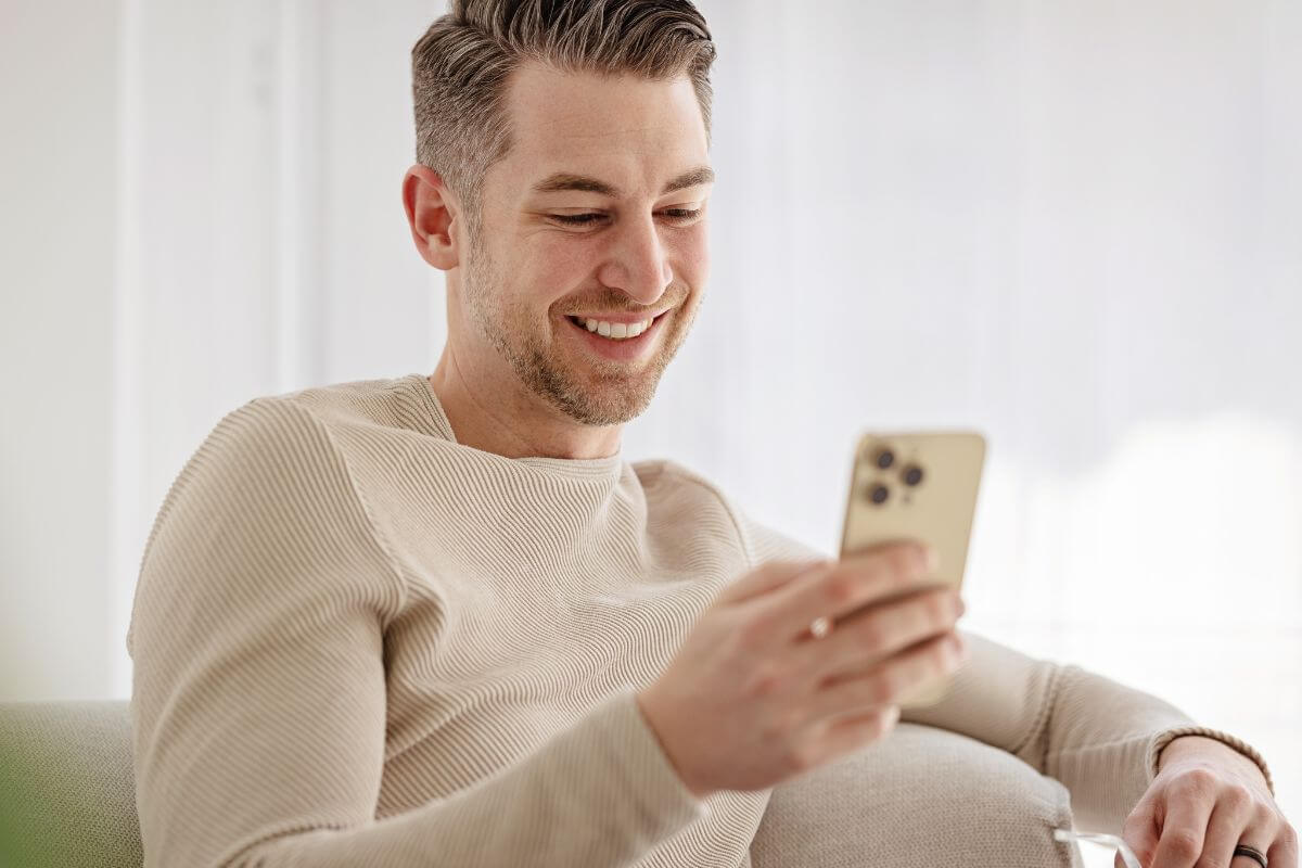 An image shows a man using a phone.