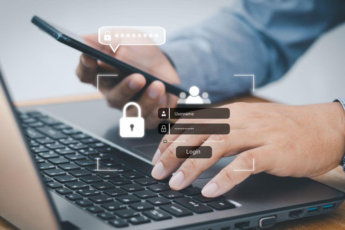 A picture shows a man using a phone and a laptop.