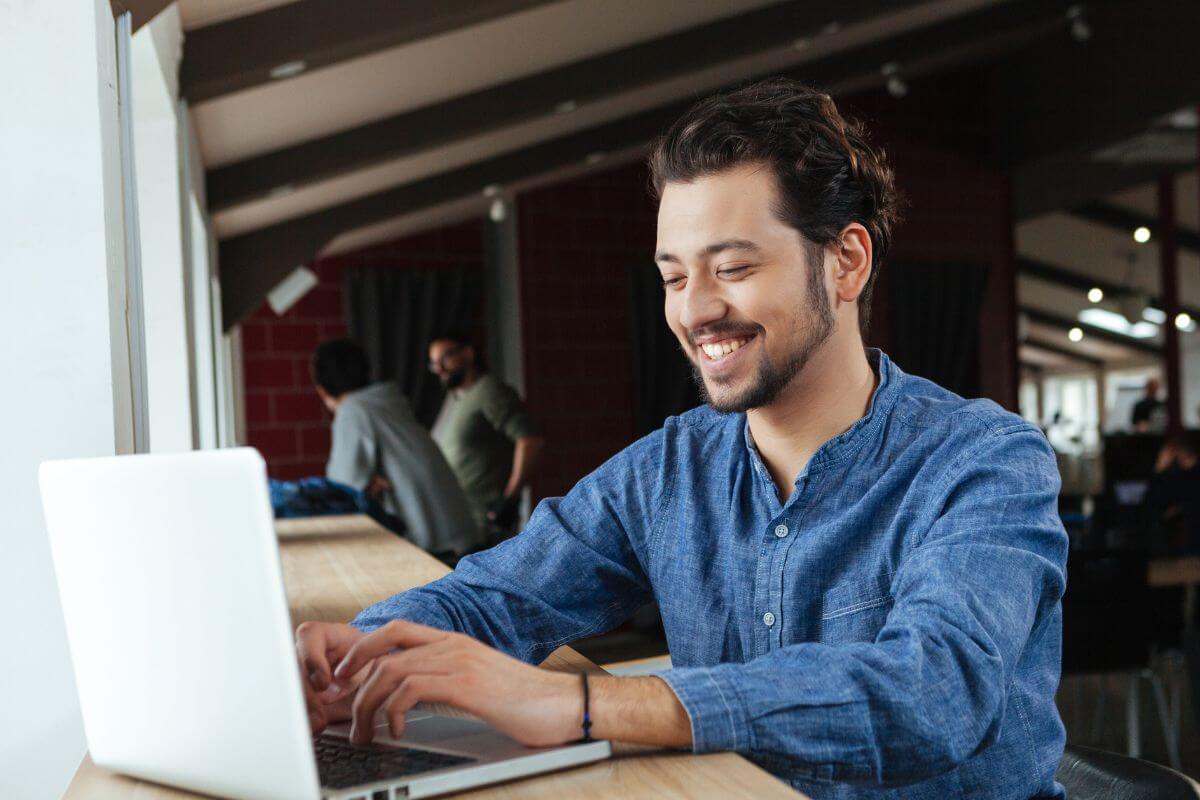 A picture shows a man using a laptop.
