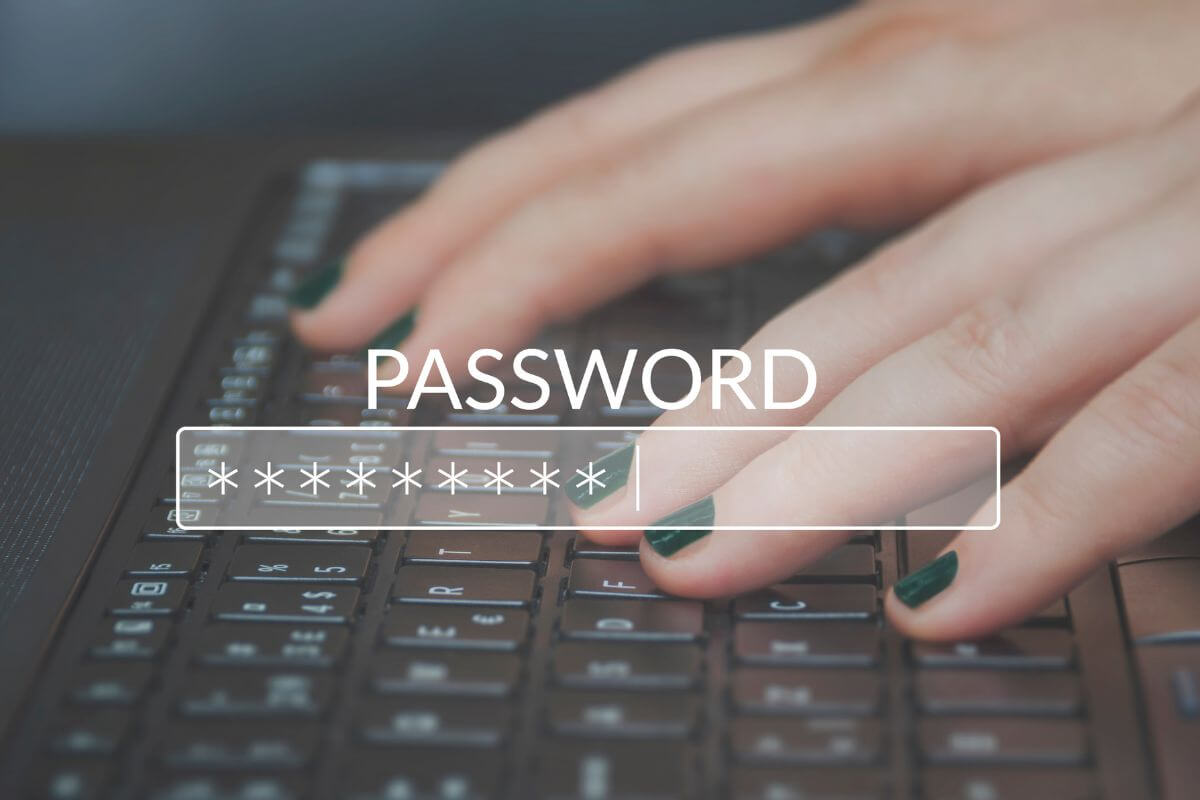 A picture shows a woman's hand typing her password.