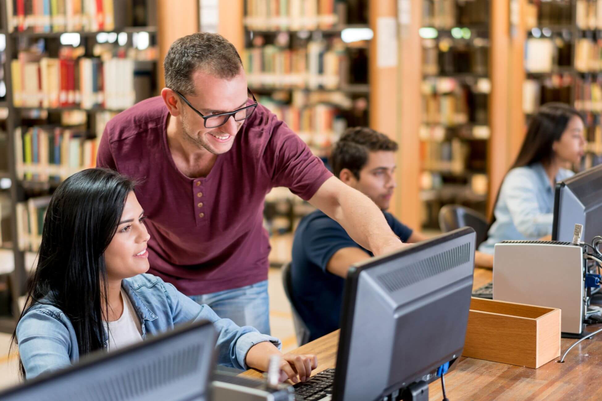 An image shows a man teaching his students.