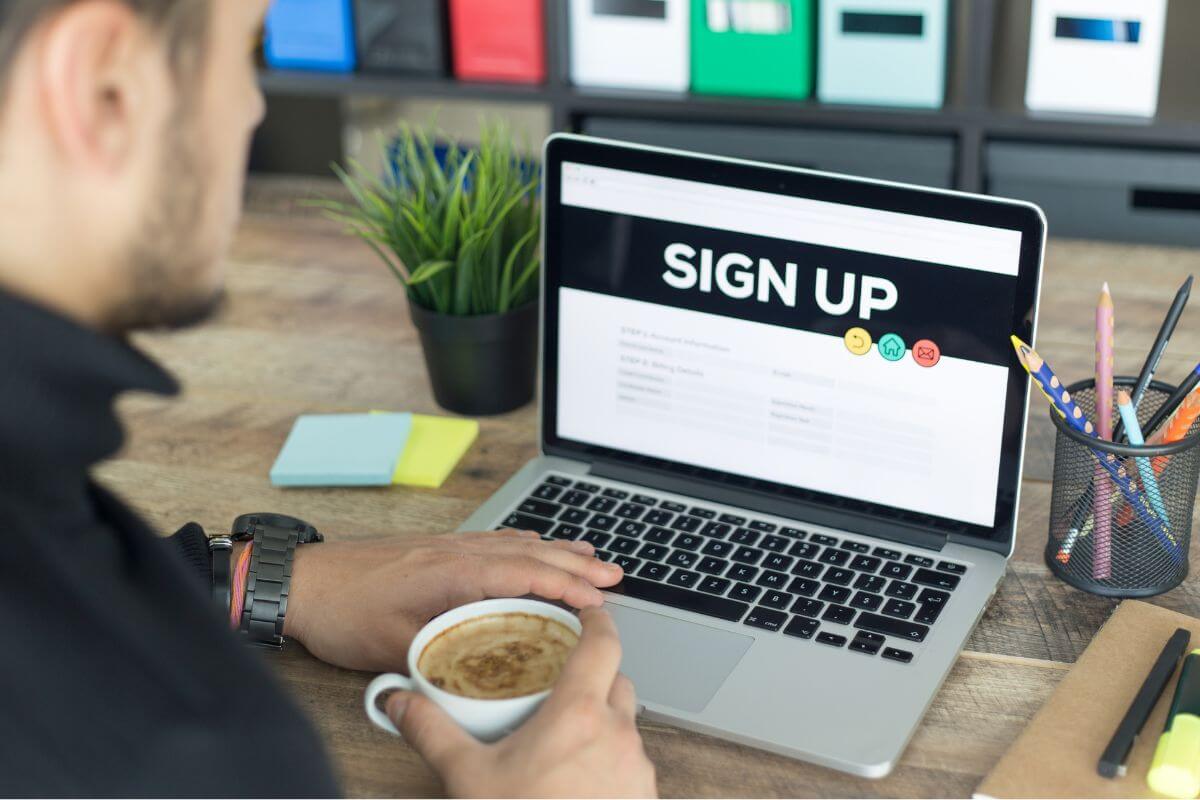 A picture of a man signing up online.