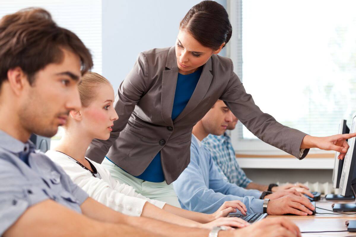 An image shows a coach teaching her students.