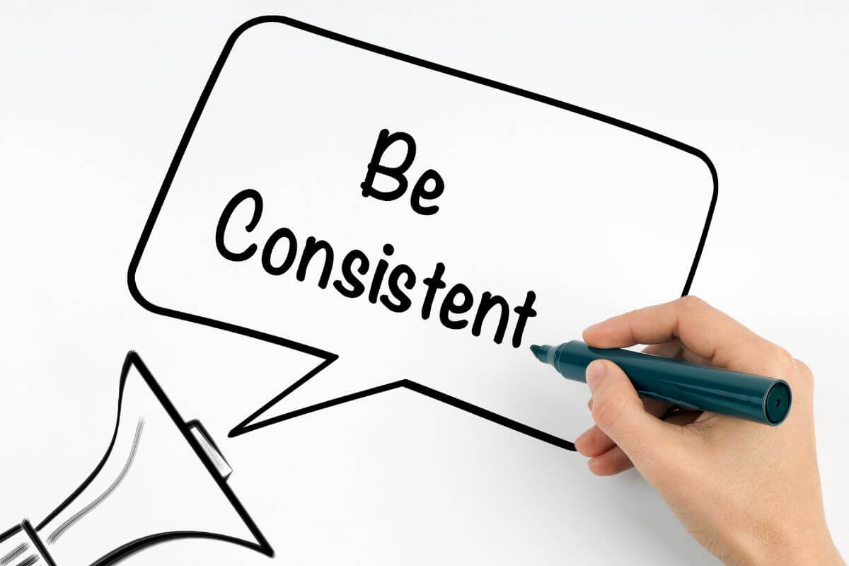 An image shows a woman's hand writing something.