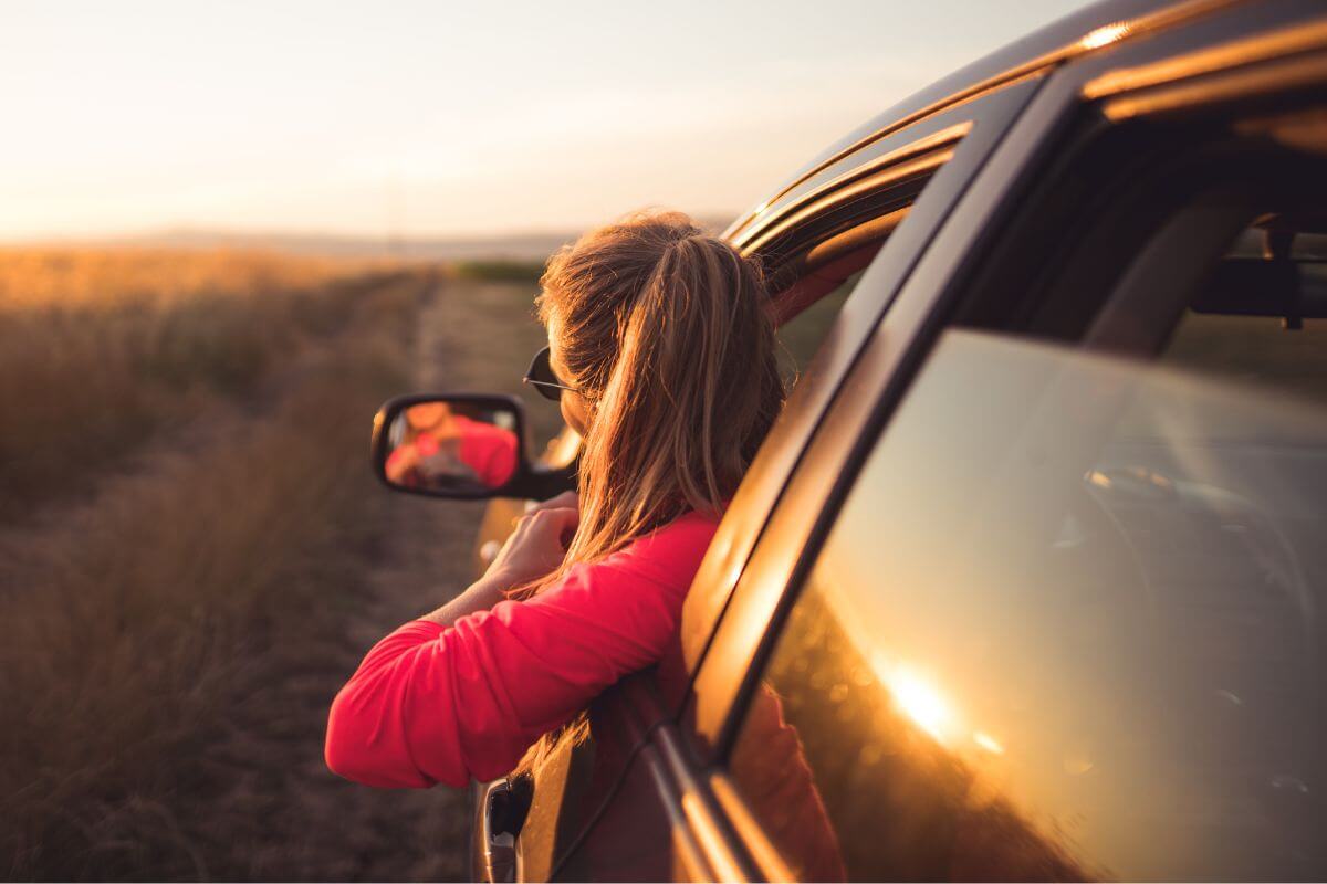 An image shows a woman in the car.