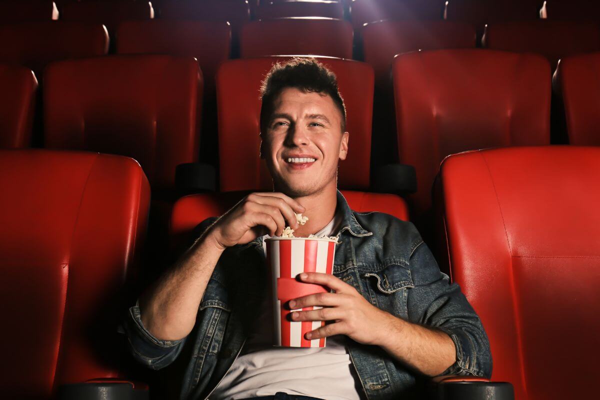 A picture shows a man watching a movie.