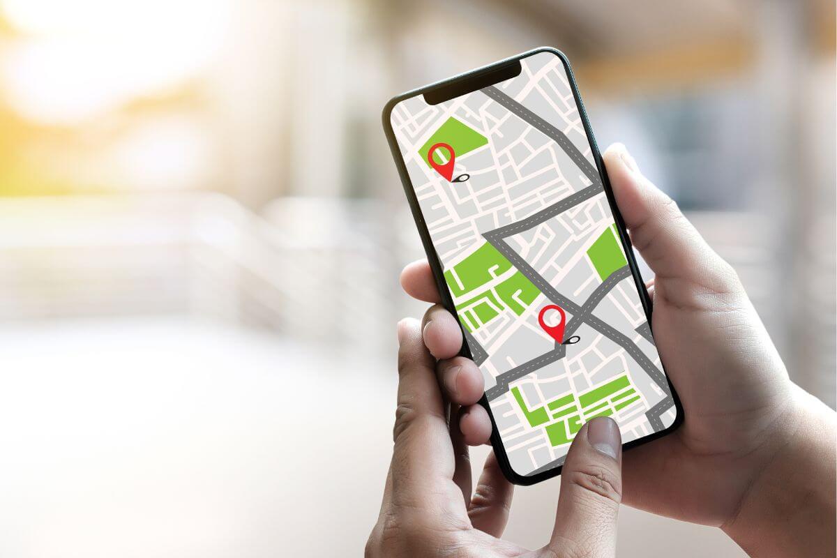 An image shows a woman's hand tracing a map.