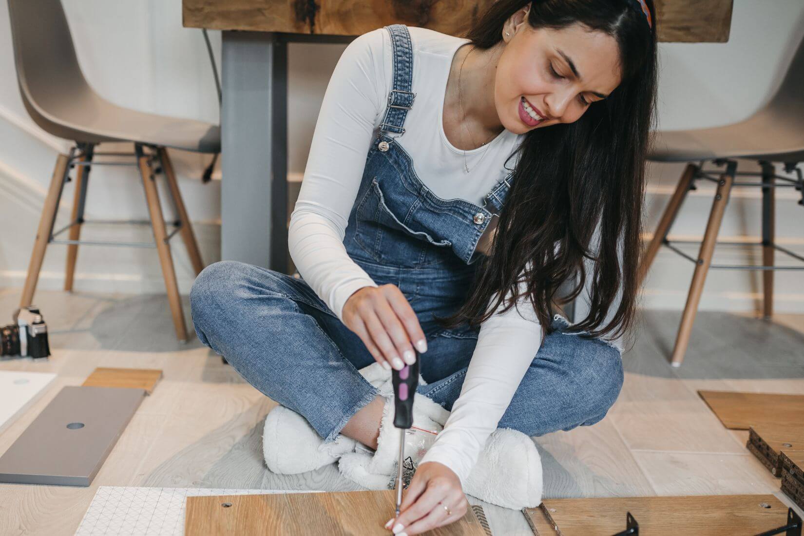 A picture if a girl fixing something.