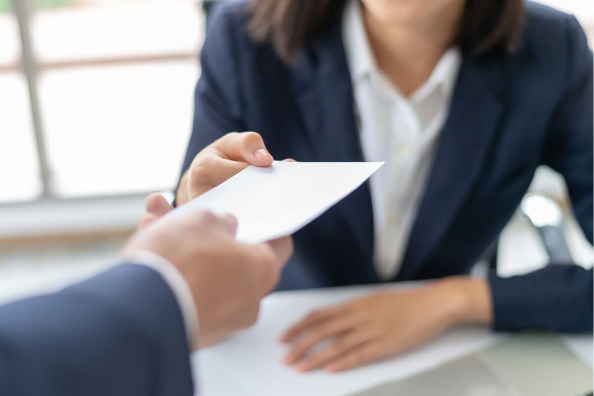 A picture shows a woman receiving her salary.
