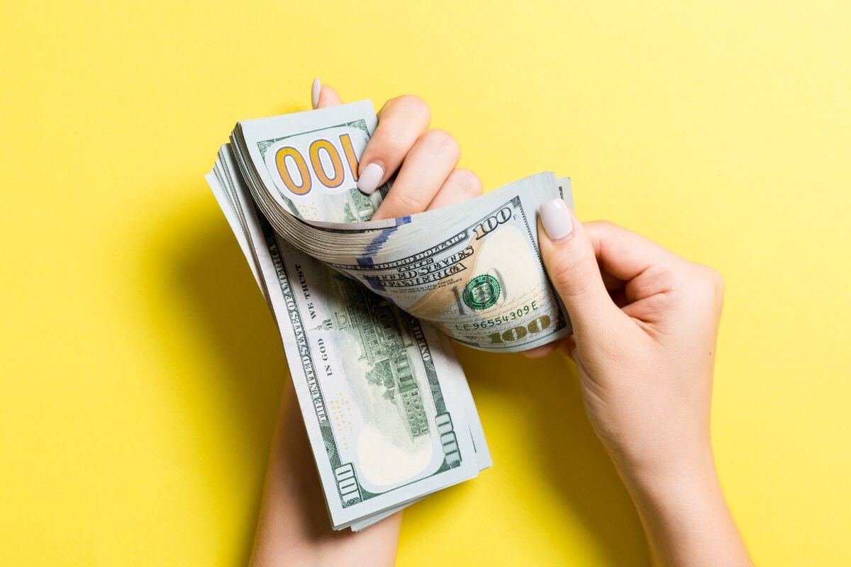 An image of a woman's hand counting money.