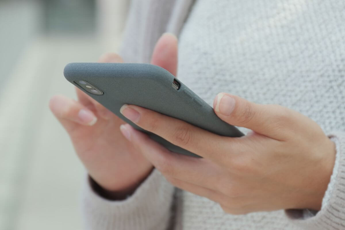 A picture of a woman using a phone.