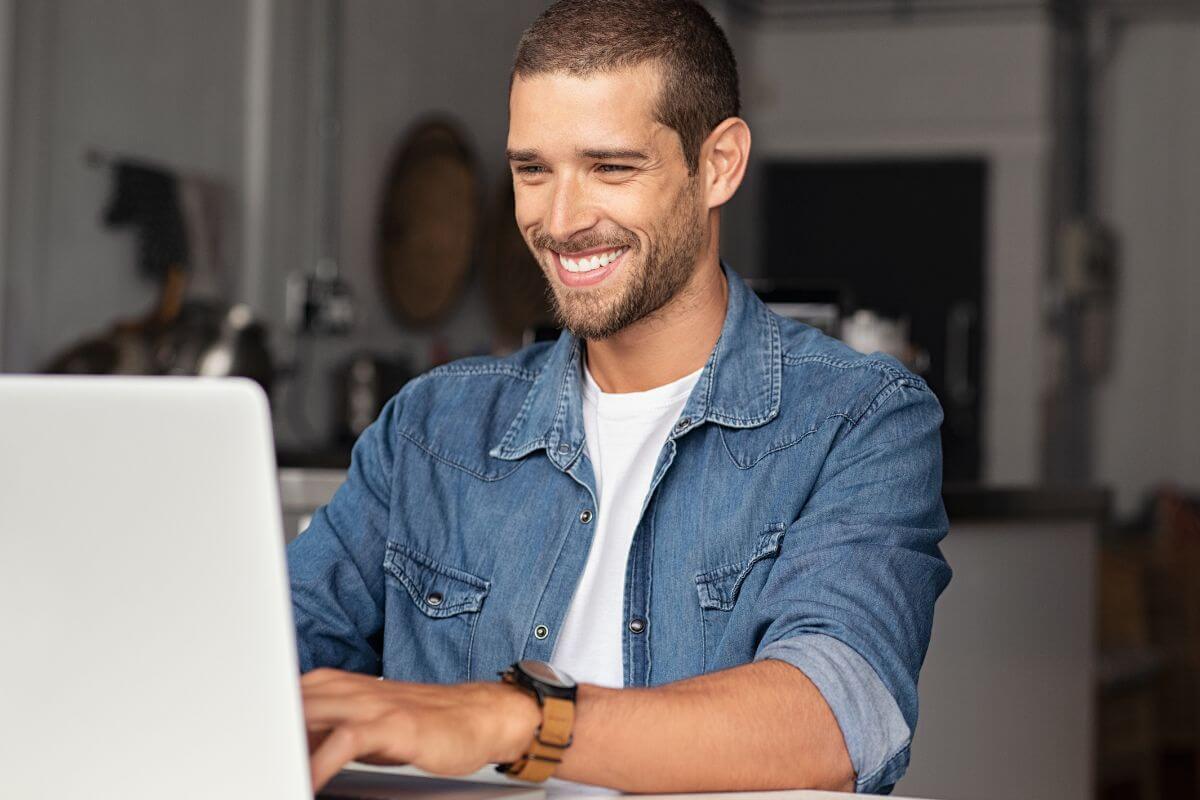 A picture shows a man using a laptop.