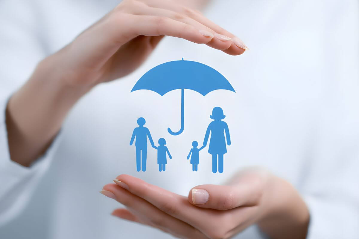 A picture of an umbrella covering a family.